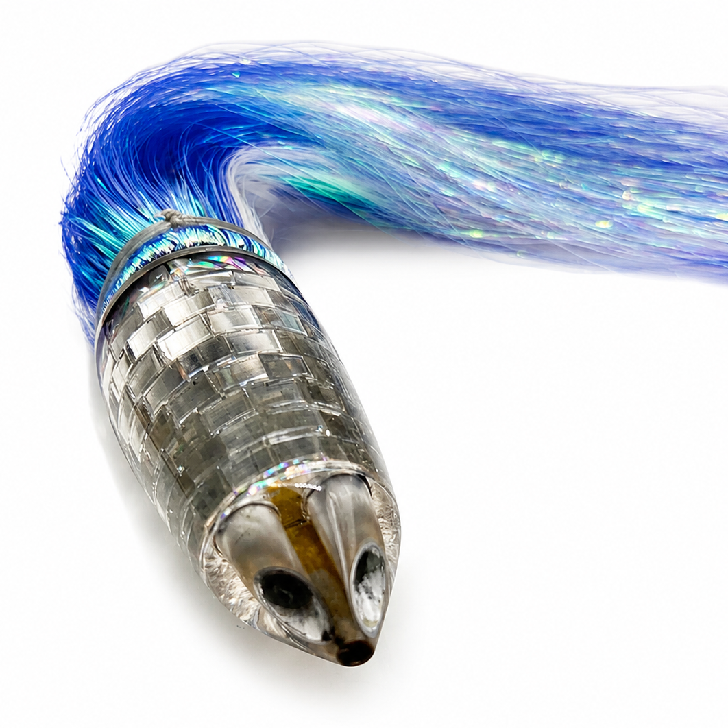 A close-up of a fishing lure with a metallic silver scaled body and vibrant blue iridescent hair tails, shown on a plain white background.